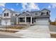 Charming two-story home featuring a two-car garage and inviting covered front porch at 9996 Racine St, Commerce City, CO 80022