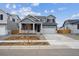 Beautiful two-story home with a two-car garage and a covered front porch entrance at 9996 Racine St, Commerce City, CO 80022