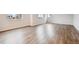 Spacious room with wood-look flooring, neutral walls, and ample natural light from the windows at 9996 Racine St, Commerce City, CO 80022