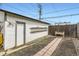 Backyard features a pathway, storage shed, and a wooden fence, perfect for outdoor activities at 2886 S Acoma St, Englewood, CO 80110