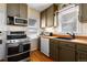 Cozy kitchen featuring stainless steel appliances and natural wood countertops at 2886 S Acoma St, Englewood, CO 80110