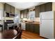 Galley kitchen featuring wood countertops, cabinetry, stainless steel appliances, and hardwood floors at 2886 S Acoma St, Englewood, CO 80110