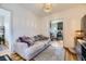 Bright living room with hardwood floors, a stylish couch, and a view into the kitchen at 2886 S Acoma St, Englewood, CO 80110
