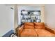 Cozy living room featuring a comfortable couch and built-in shelving, ideal for relaxation at 2886 S Acoma St, Englewood, CO 80110
