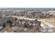 Aerial view of brick condominium complex near shops with water feature at 2897 W Riverwalk Cir # 204, Littleton, CO 80123