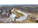 Picturesque aerial of residences overlooking frozen pond and surrounding golf course, combining natural beauty and community charm at 2897 W Riverwalk Cir # 204, Littleton, CO 80123