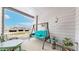 Balcony with cozy swing seat, table and chairs, and views of community green space at 2897 W Riverwalk Cir # 204, Littleton, CO 80123