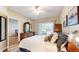 Cozy bedroom with sliding glass door and a large dresser and mirror at 2897 W Riverwalk Cir # 204, Littleton, CO 80123