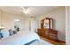 Comfortable bedroom with a ceiling fan and a large wooden dresser with a mirror at 2897 W Riverwalk Cir # 204, Littleton, CO 80123