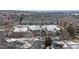 A stately clubhouse with a circular driveway is situated among the community's residences and snow-covered landscaping at 2897 W Riverwalk Cir # 204, Littleton, CO 80123