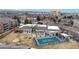 Aerial view of community clubhouse with outdoor patio, grill and fenced pool, set against a backdrop of lush greenery at 2897 W Riverwalk Cir # 204, Littleton, CO 80123