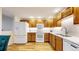 Well-lit kitchen featuring modern appliances and light wood cabinetry at 2897 W Riverwalk Cir # 204, Littleton, CO 80123