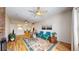 Open-concept living room featuring hardwood floors, ceiling fans and serene, comfortable furnishings at 2897 W Riverwalk Cir # 204, Littleton, CO 80123