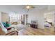 Bright and airy living room with fireplace, ceiling fan, and light hardwood floors at 2897 W Riverwalk Cir # 204, Littleton, CO 80123
