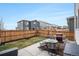 Fenced backyard with a patio area, BBQ grill, fire pit, and outdoor seating at 1408 Brookfield Pl, Lafayette, CO 80026