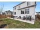 Spacious backyard featuring a patio, seating, and a well-maintained lawn, perfect for outdoor entertaining at 1408 Brookfield Pl, Lafayette, CO 80026