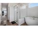 Modern bathroom featuring a glass-enclosed shower and a standalone soaking tub at 1408 Brookfield Pl, Lafayette, CO 80026