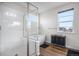 Stylish bathroom features a glass shower, soaking tub, and large window with a view at 1408 Brookfield Pl, Lafayette, CO 80026