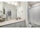 Clean bathroom boasts vanity, marble countertop, and bathtub with tile surround at 1408 Brookfield Pl, Lafayette, CO 80026
