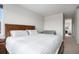 Bright bedroom features wood accents, a comfortable bed, and a convenient crib at 1408 Brookfield Pl, Lafayette, CO 80026