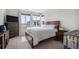 Serene bedroom with a queen bed, dresser, large windows, and lots of natural light at 1408 Brookfield Pl, Lafayette, CO 80026