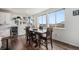 Bright dining area featuring large windows, a wooden table with leather chairs, and stylish decor at 1408 Brookfield Pl, Lafayette, CO 80026