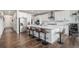 Modern kitchen featuring white cabinets, stainless steel appliances, and a large island with bar seating at 1408 Brookfield Pl, Lafayette, CO 80026