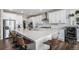 Bright, spacious kitchen with white cabinets, large island, stainless steel appliances and bar stool seating at 1408 Brookfield Pl, Lafayette, CO 80026