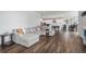 Open-concept living room with a plush sectional sofa, hardwood floors, and seamless access to the kitchen at 1408 Brookfield Pl, Lafayette, CO 80026