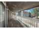 View of apartment building from covered balcony with wood flooring at 18071 E Kentucky Ave # 203, Aurora, CO 80017