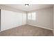 Bedroom featuring neutral paint, newer carpet, and a closet with sliding doors at 18071 E Kentucky Ave # 203, Aurora, CO 80017