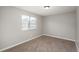 Bright bedroom has neutral paint, newer carpet, and natural light from a window at 18071 E Kentucky Ave # 203, Aurora, CO 80017
