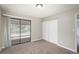 Bedroom features sliding glass doors to a balcony and a closet with sliding doors at 18071 E Kentucky Ave # 203, Aurora, CO 80017