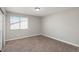 Bright bedroom has neutral paint, newer carpet, and natural light from a window at 18071 E Kentucky Ave # 203, Aurora, CO 80017