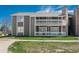 Two-story condo building with a white railed porch and green lawn at 18071 E Kentucky Ave # 203, Aurora, CO 80017