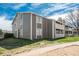Condo building exterior featuring gray siding and well-kept landscaping at 18071 E Kentucky Ave # 203, Aurora, CO 80017