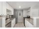 Well-lit kitchen features stainless steel appliances, light granite countertops, and white cabinets at 18071 E Kentucky Ave # 203, Aurora, CO 80017
