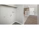 Bright laundry room with overhead shelf and utility connections, perfect for in-home convenience at 18071 E Kentucky Ave # 203, Aurora, CO 80017