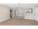 Inviting living room open to the kitchen with neutral paint and carpet at 18071 E Kentucky Ave # 203, Aurora, CO 80017