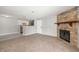Comfortable living room with a stone fireplace and an opening to the kitchen at 18071 E Kentucky Ave # 203, Aurora, CO 80017