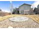 Exterior view of the home and backyard featuring a stone patio and a partially covered deck at 2305 Dogwood Cir, Erie, CO 80516