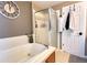 Well-lit bathroom featuring a soaking tub and glass shower enclosure at 2305 Dogwood Cir, Erie, CO 80516