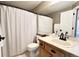Well-lit bathroom featuring a shower with a decorative curtain and neutral decor at 2305 Dogwood Cir, Erie, CO 80516