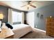 Cozy bedroom featuring neutral tones, a ceiling fan, and natural wood accents at 2305 Dogwood Cir, Erie, CO 80516