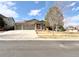 Street view of a well-kept ranch-style home with a three-car garage and neat landscaping at 2305 Dogwood Cir, Erie, CO 80516