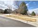 Street view of a lovely ranch-style home with a three-car garage and mature trees in the front yard at 2305 Dogwood Cir, Erie, CO 80516