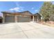 Charming ranch home featuring a three-car garage, stone accents, and beautiful landscaping at 2305 Dogwood Cir, Erie, CO 80516
