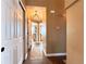 Hallway with wood floors, wainscoting, and neutral walls leading to various rooms at 2305 Dogwood Cir, Erie, CO 80516