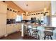 Bright kitchen featuring white cabinets, granite counters, a kitchen island, and stainless steel appliances at 2305 Dogwood Cir, Erie, CO 80516