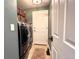Convenient laundry room with front load washer/dryer and overhead storage at 2305 Dogwood Cir, Erie, CO 80516